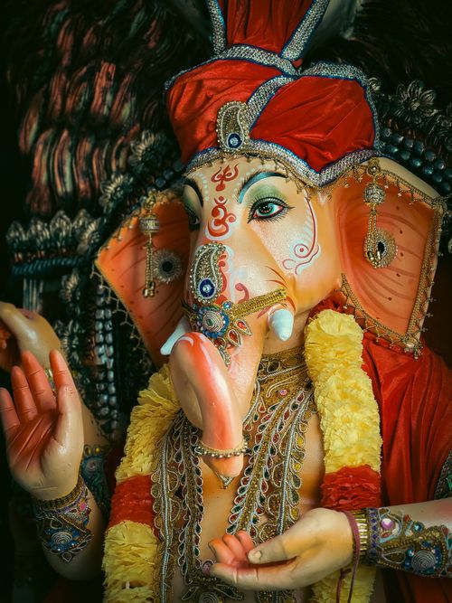 Free Close-up of a colorful Ganesha statue, showcasing detailed craftsmanship and vibrant attire. Stock Photo