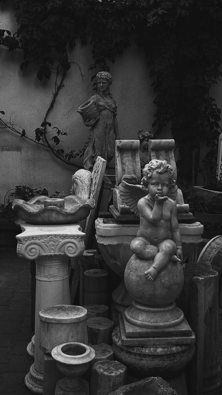 Black And White Photo Of Angel Sculpture In A Shop