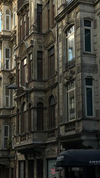 Detailed view of a historic building facade with bay windows in an urban district.