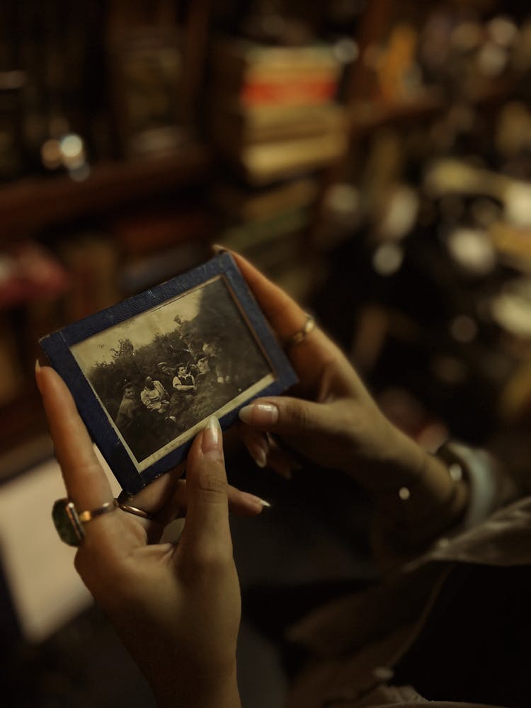 Woman Looking At Old Photo