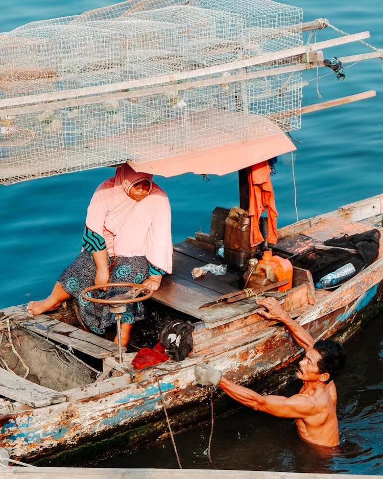 Man And Woman On An Old Boat