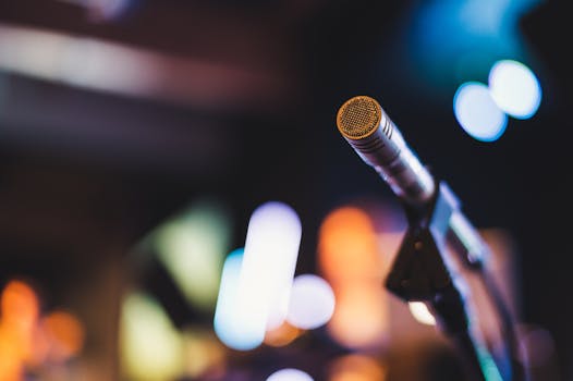 Dynamic microphone in focus with a blurred colorful background, perfect for concert and event themes.