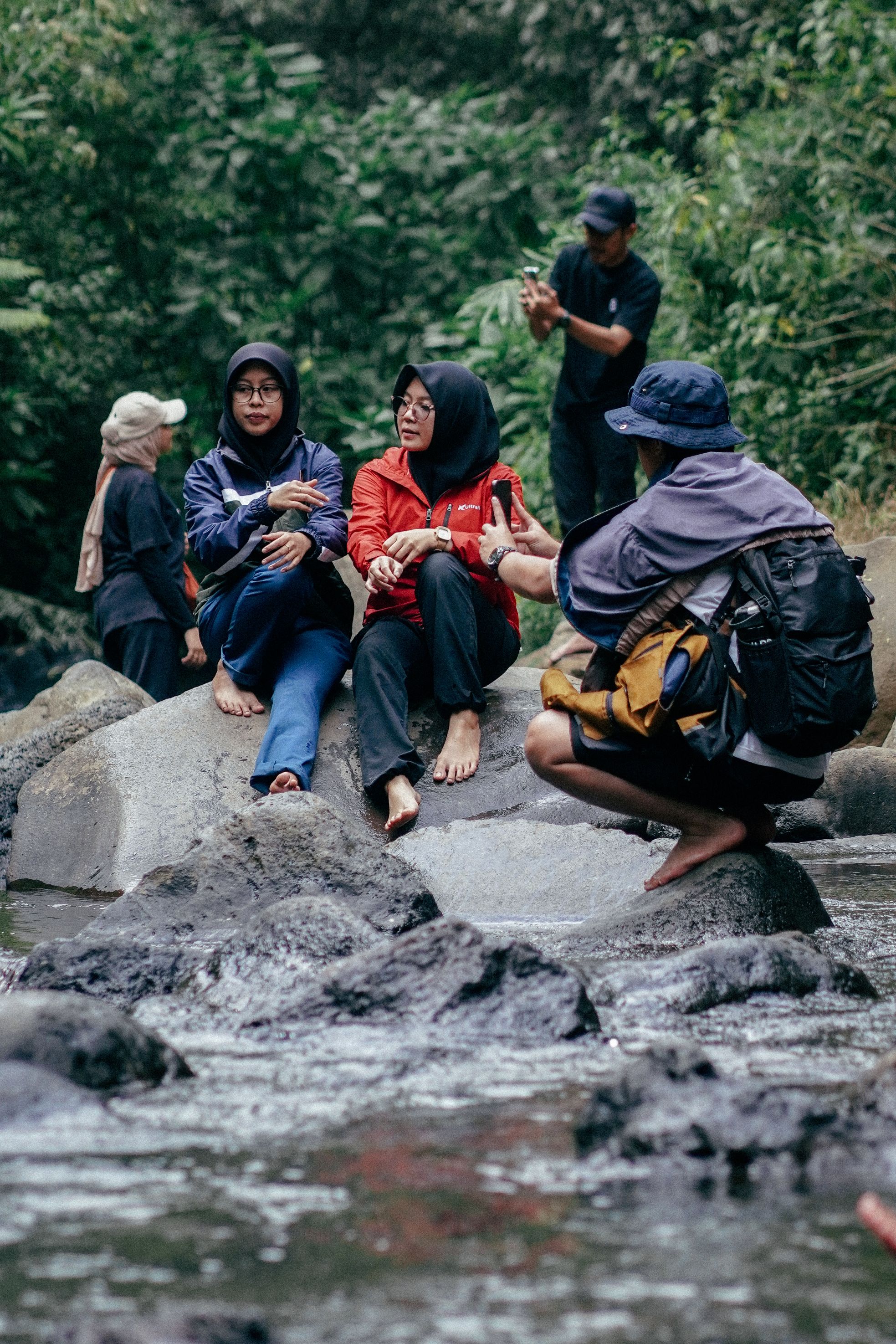 A Group of People Sitting on Rocks in Mountains · Free Stock Photo