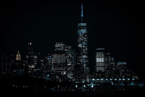 Free Dramatic view of New York City's illuminated skyline at night showcasing modern architecture. Stock Photo