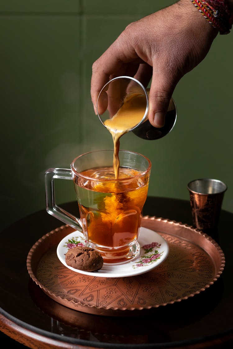 Pouring Coffee To Glass Cup Of Water