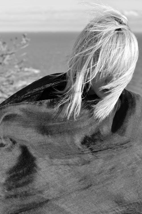 Blonde Woman with Windblown Hair in Black Cloth