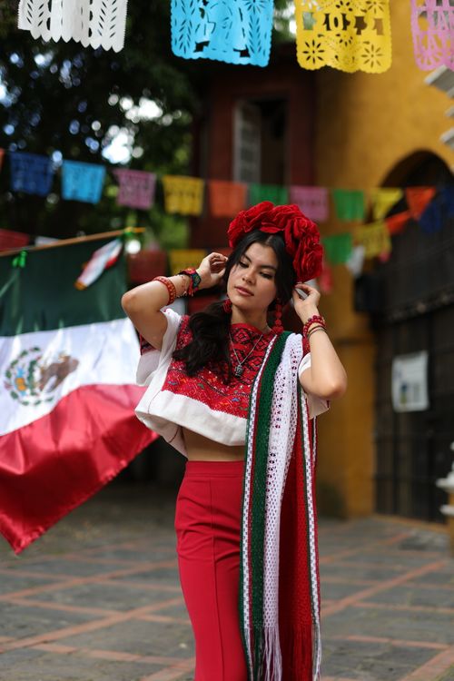 Free A young woman in vibrant traditional Mexican attire celebrates culture outdoors. Stock Photo