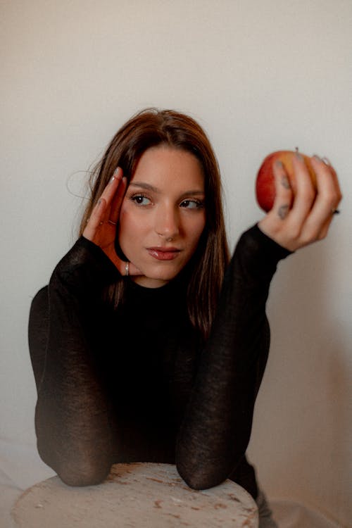 Young Woman Holding an Apple