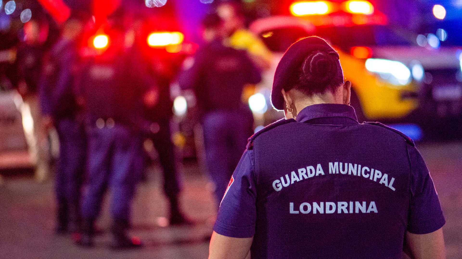 Modafinil for Security Guards: Enhancing Vigilance A municipal guard stands on duty in the vibrant streets of Londrina at night — modafinil for security guards