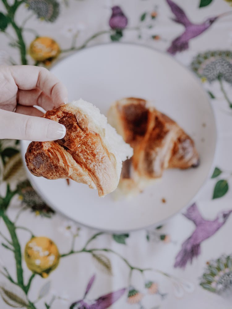 Woman Hand Holding Croissant