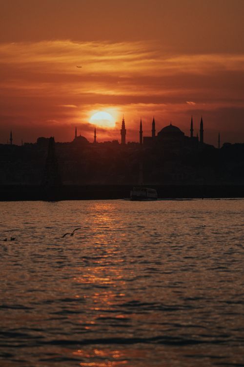 Free Dramatic sunset over Istanbul's skyline with silhouetted mosques and vibrant orange hues. Stock Photo