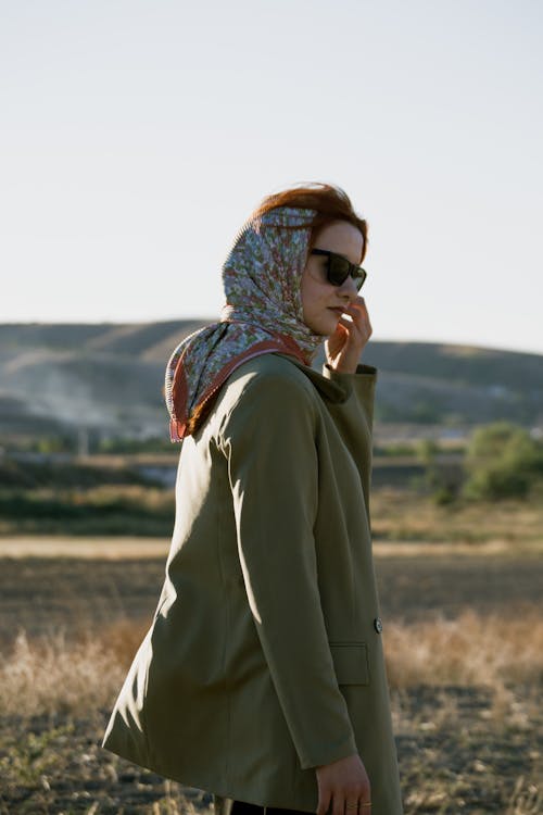 Woman in a Headscarf and an Olive Jacket in a Field