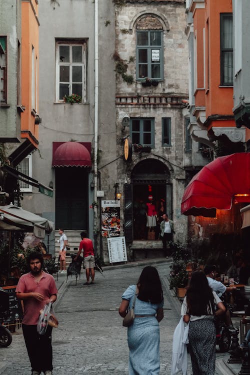 People Walking in a Cobblestone Alley between Buildings in Istanbul, Turkey 