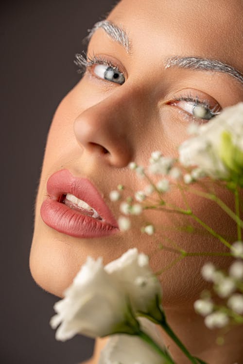 Woman with Eyelashes and Eyebrows Painted Silver