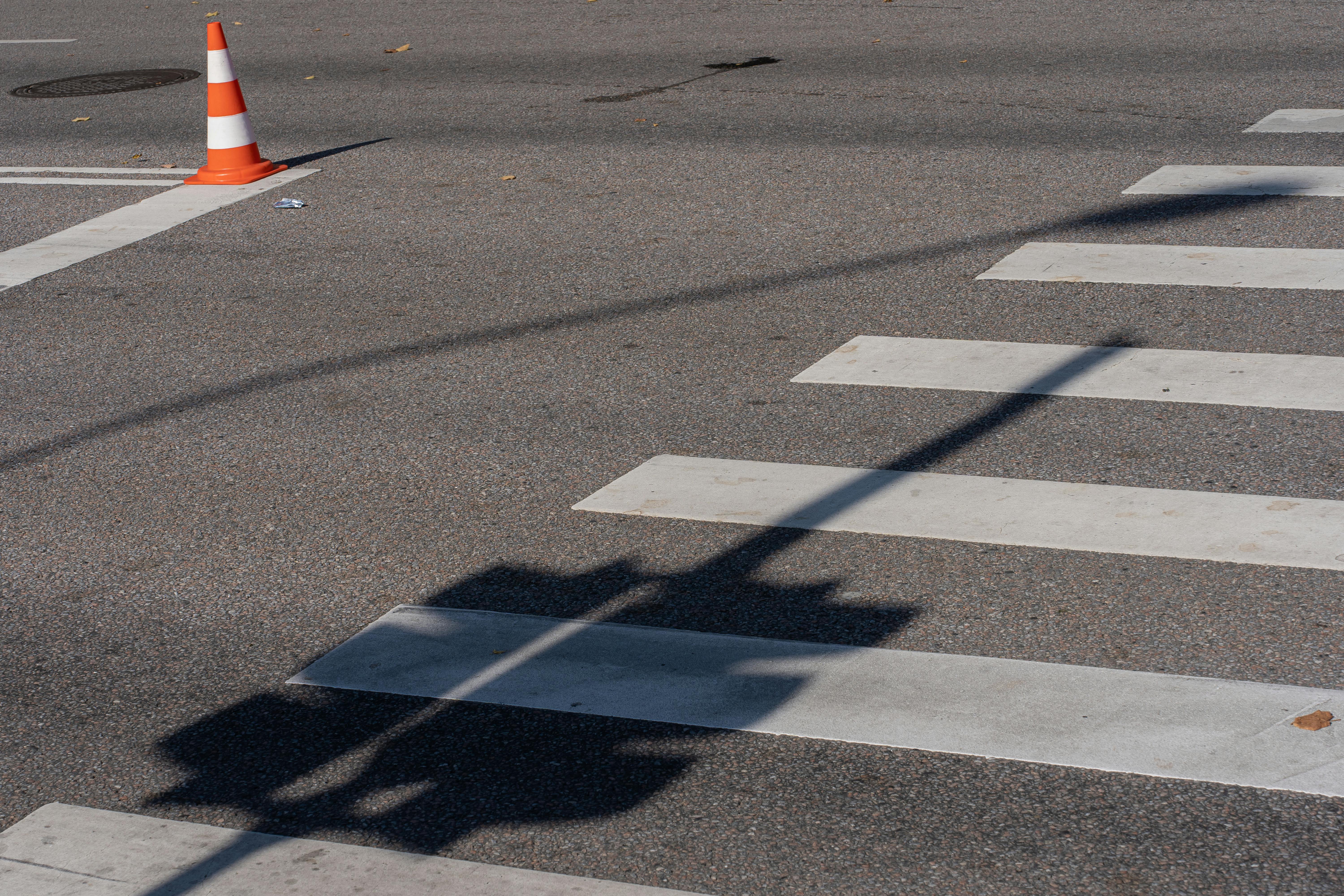 a street with a crosswalk and traffic cones