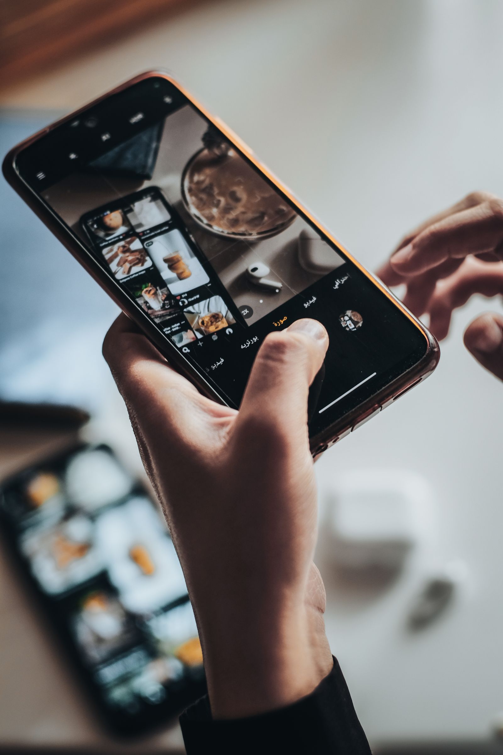 Hands using a smartphone to photograph a scene