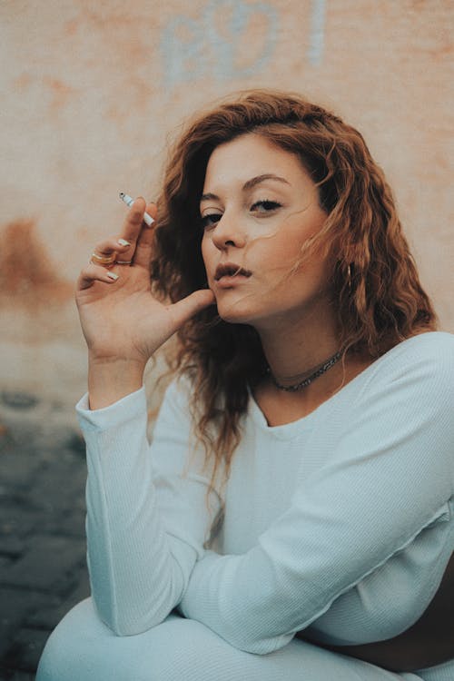Woman in White Shirt Smoking Cigarette