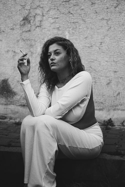 Woman Sitting with Cigarette in Black and White