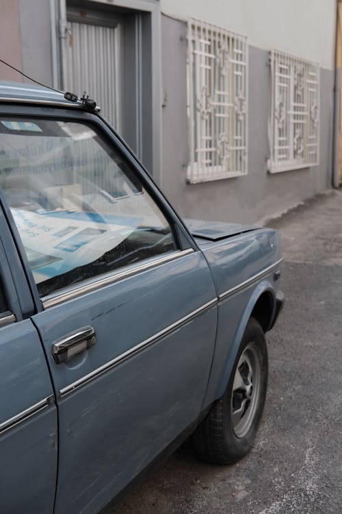 A Vintage Car Parked in front of a Building