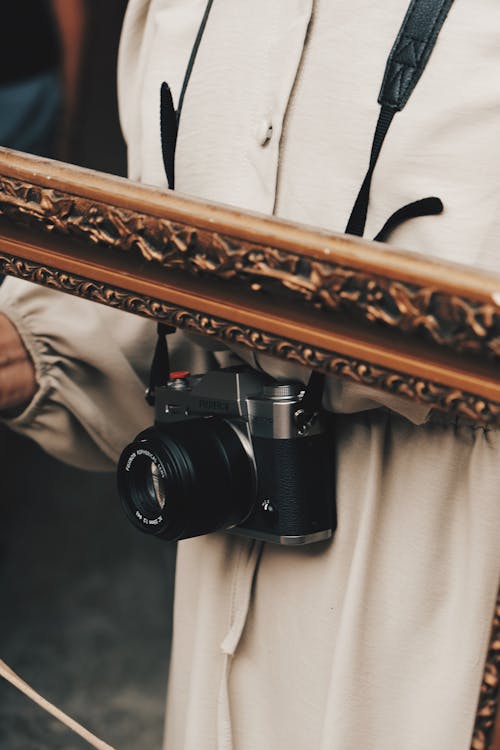 Fujifilm X-T30 Digital Camera in an Empty Picture Frame Carried by the Photographer