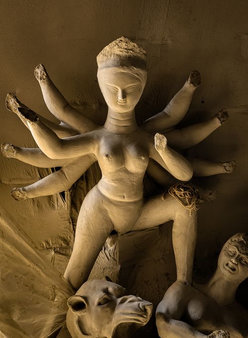Free Intricate clay sculpture of a multi-armed Hindu goddess crafted in a Kolkata studio, showcasing traditional artistry. Stock Photo