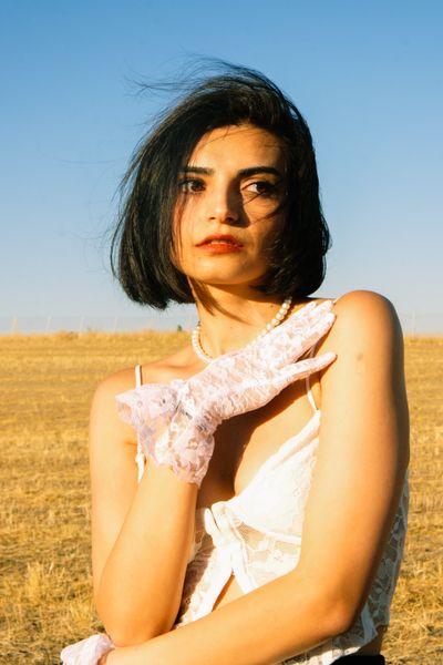 Woman in a golden field, photo by Beyzaa Yurtkuran on Pexels
