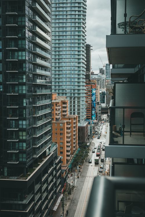 Free A busy urban street lined with towering modern skyscrapers in downtown. Stock Photo