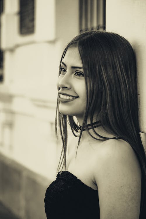 Smiling Woman Standing by Wall