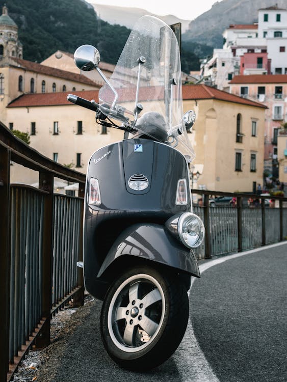 Parked Scooter Beside Railing