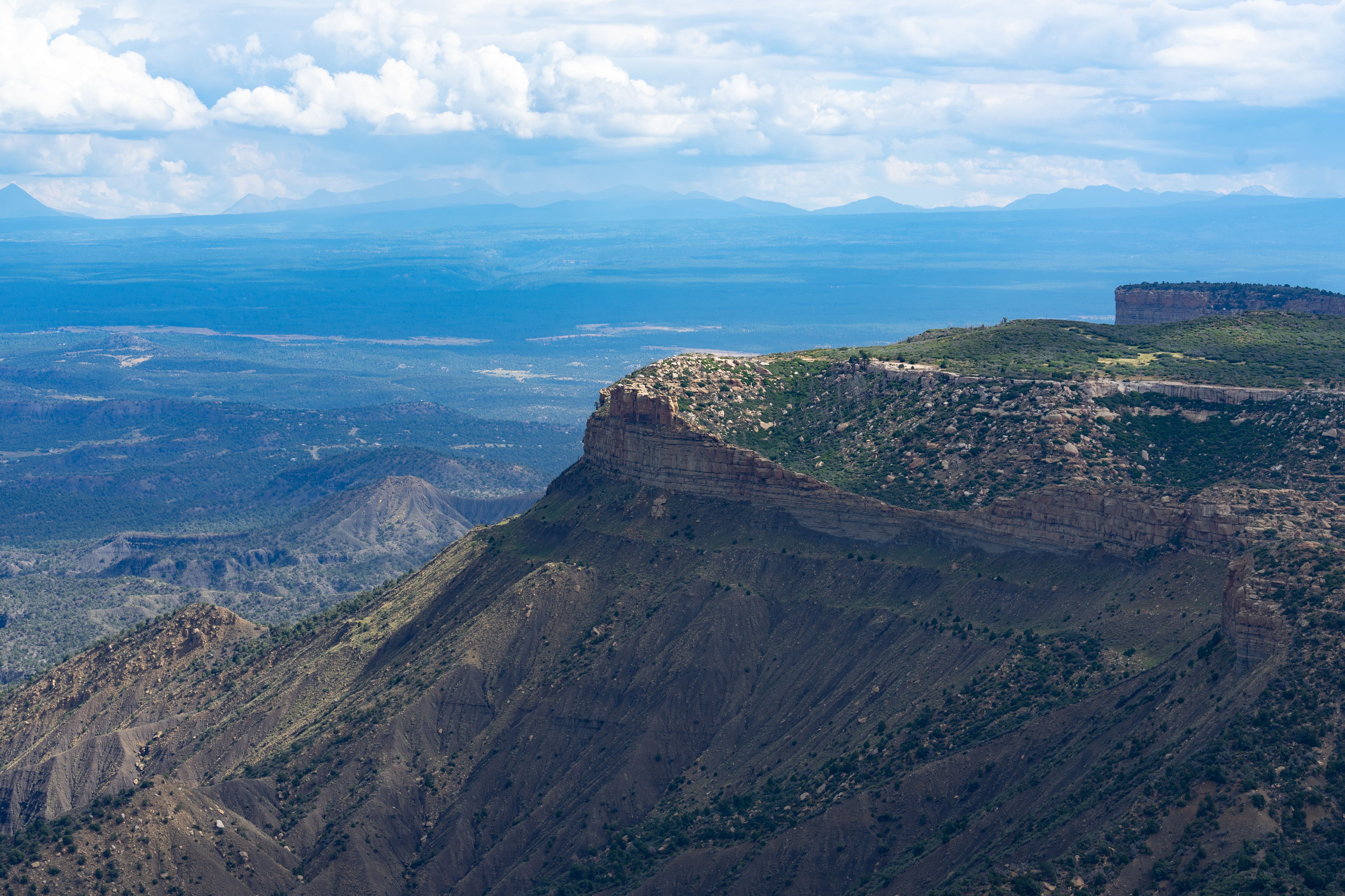 Explore the stunning aerial view of the majestic Mesa Verde cliffs in Colorado, showcasing nature's beauty.