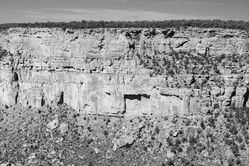 Black and White Photo of a Cliff in a Canyon 