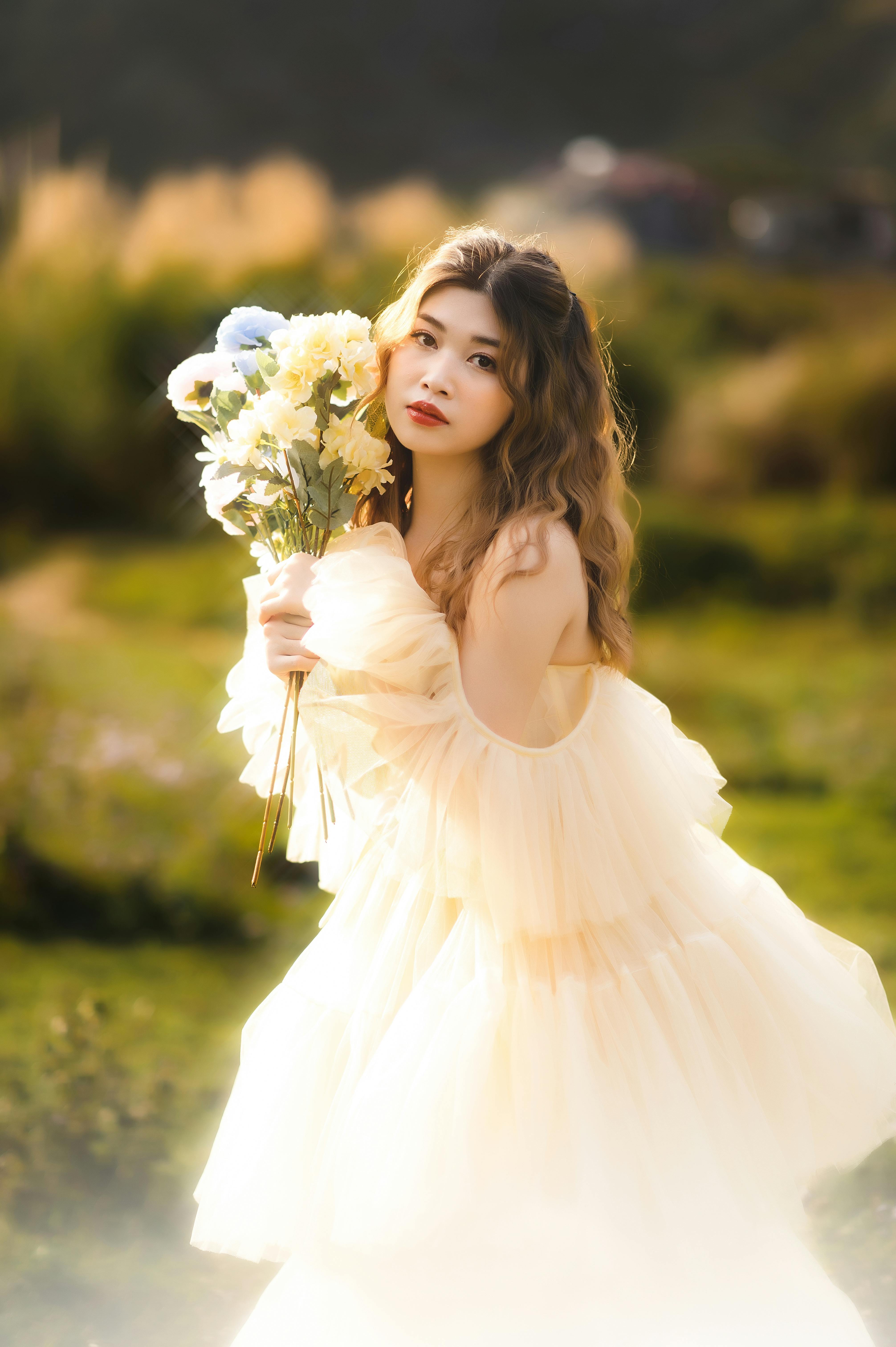 young woman in a tulle dress holding flowers