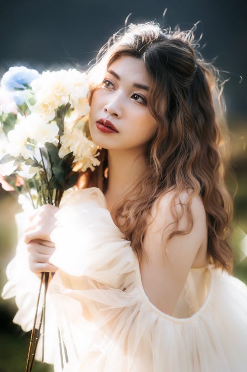 Young Woman in a Tulle Dress Holding Flowers