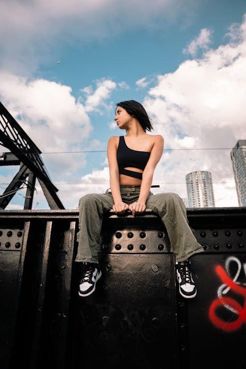 Model Posing in Asymmetric Black Top and Pants in City