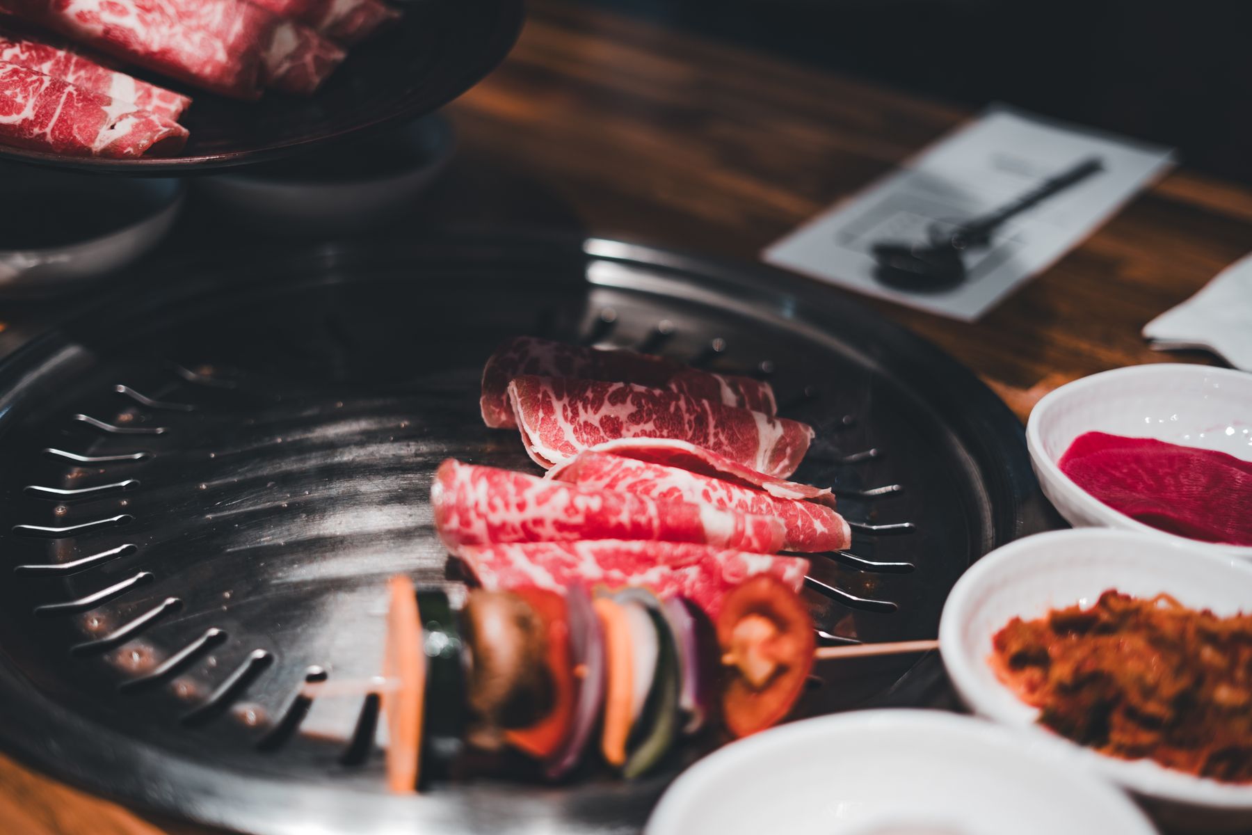 Marbled beef and vegetables searing on a tabletop grill — Erik Mclean on Pexels