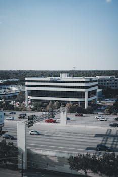 Aerial view of a modern office building and highway traffic in Houston, Texas