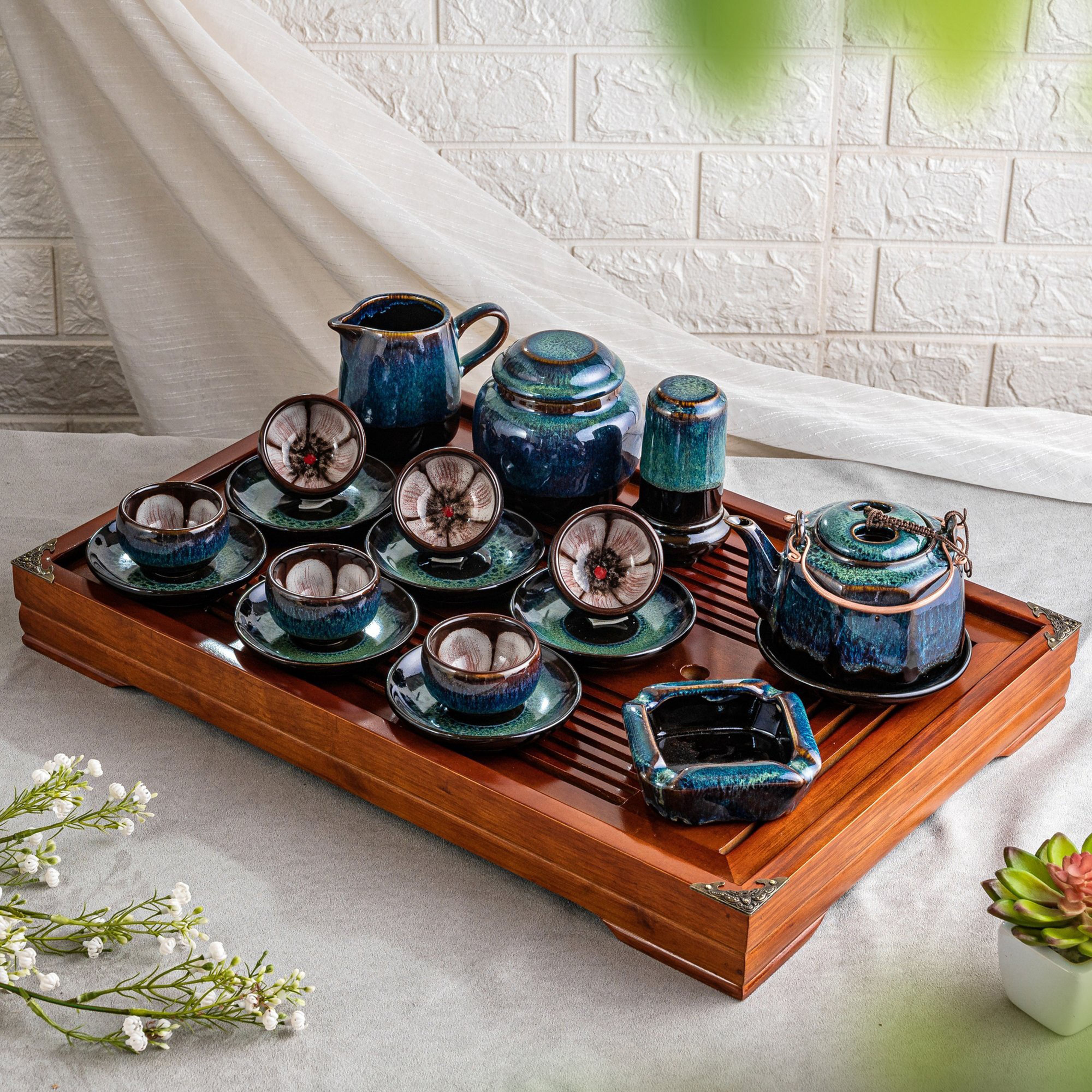 Hand-painted ceramic tea set on a wooden tray. Photo by Su Bat Trang on Pexels