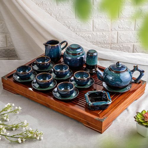 Free Stylish porcelain tea set displayed on a wooden tray, perfect for tea ceremonies or home decor. Stock Photo