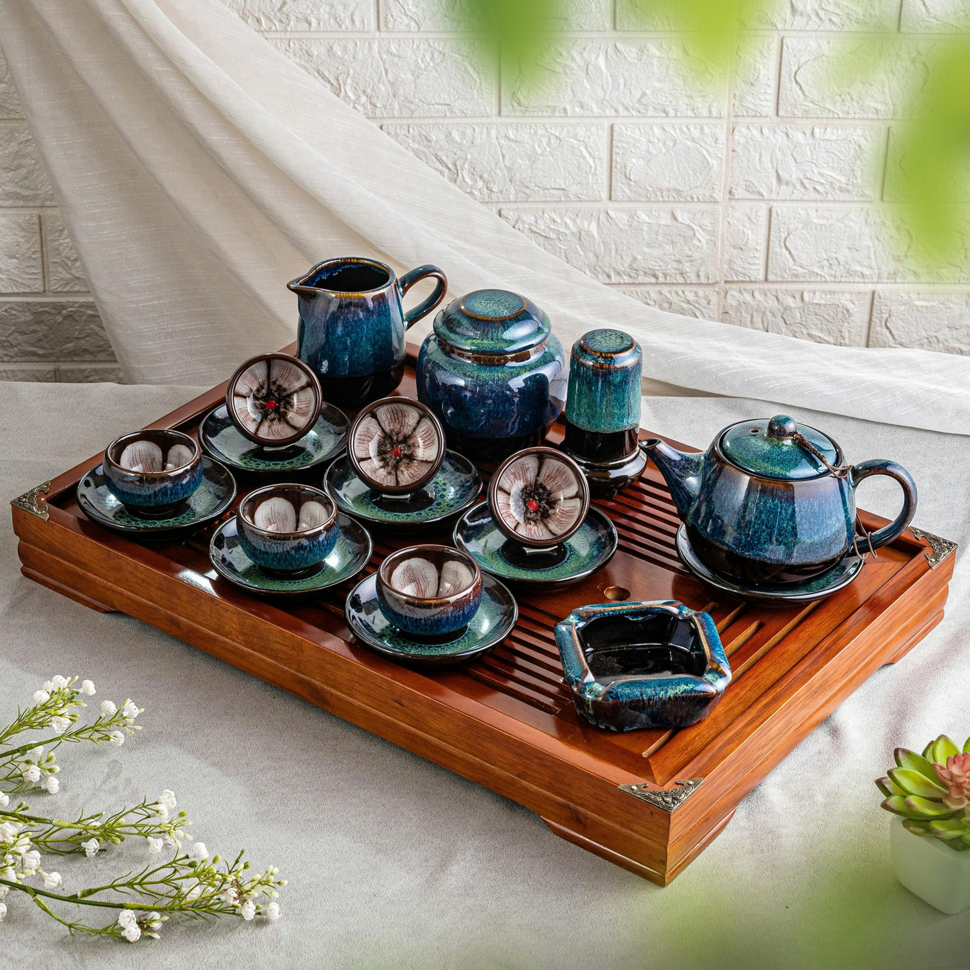 Beautiful ceramic tea set with detailed cups on a wooden tray, perfect for cultural tea ceremonies.