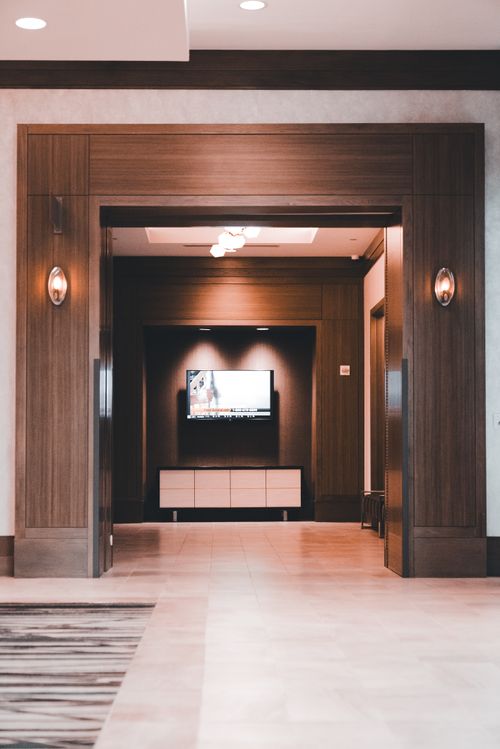 Free Elegant modern hallway with wooden features, minimalistic decor, and warm lighting. Stock Photo