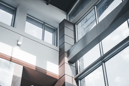 A modern architectural interior focusing on minimalist design and large windows.