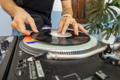 A person is playing a record on a turntable