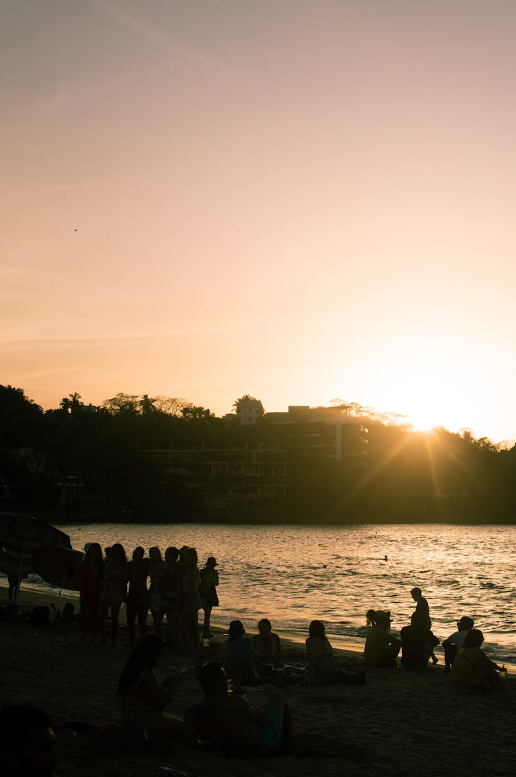 People On Sea Shore At Sunset