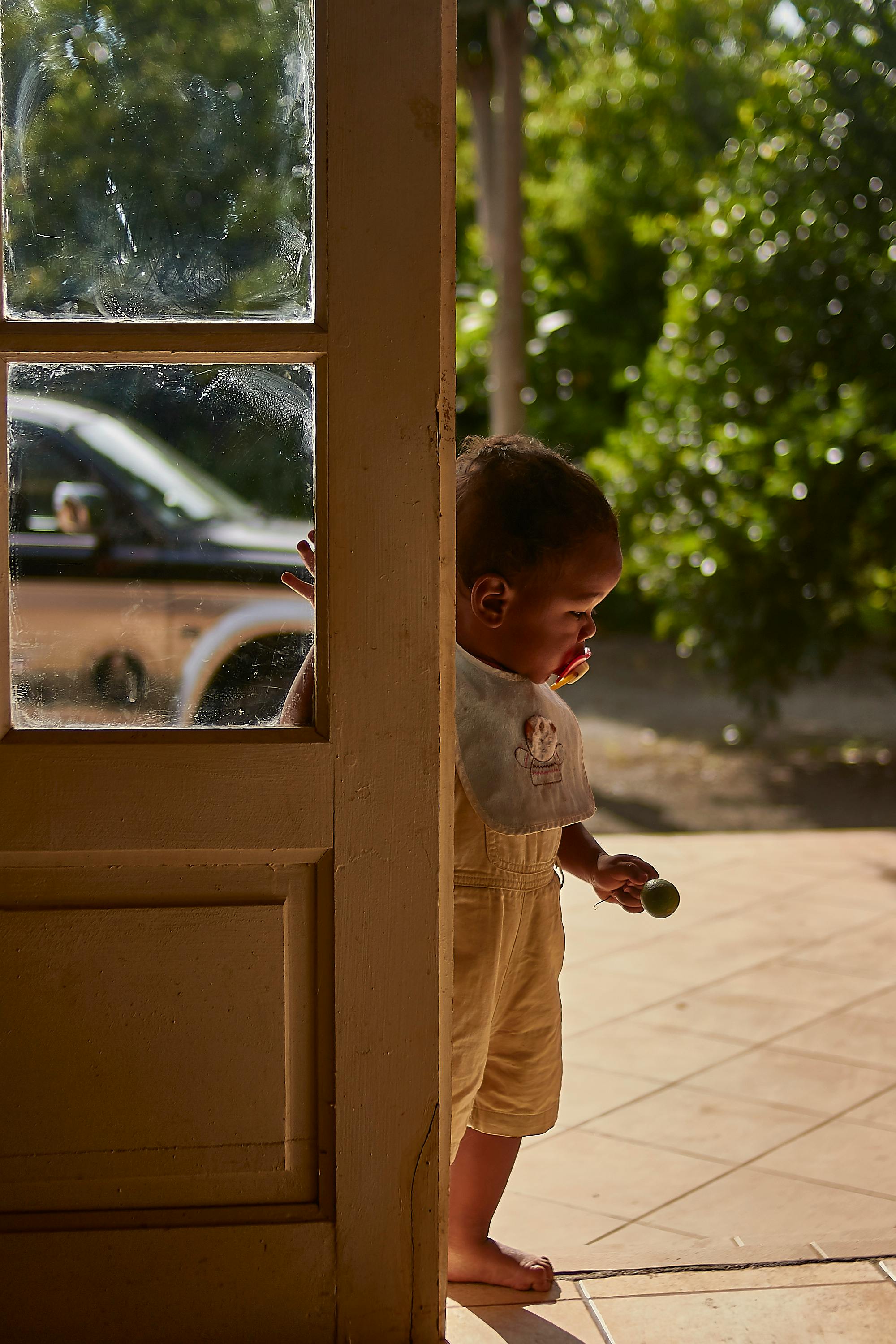 photo of baby boy with pacifier and bib