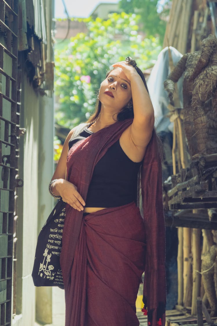 Brunette Woman Posing In Burgundy Saree And Black Top