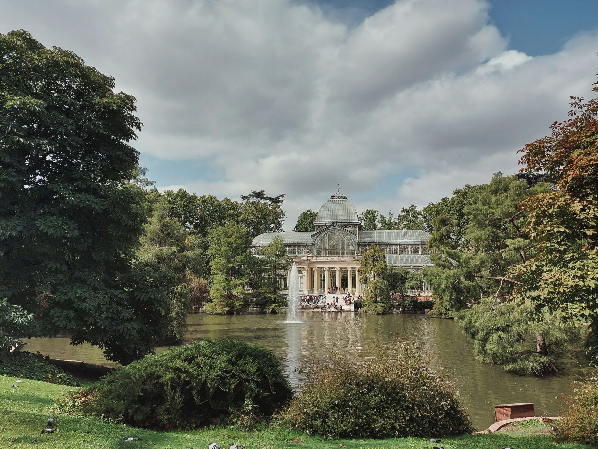Panorama of a Park with Palacio de Cristal Conservatory in Madrid, Spain