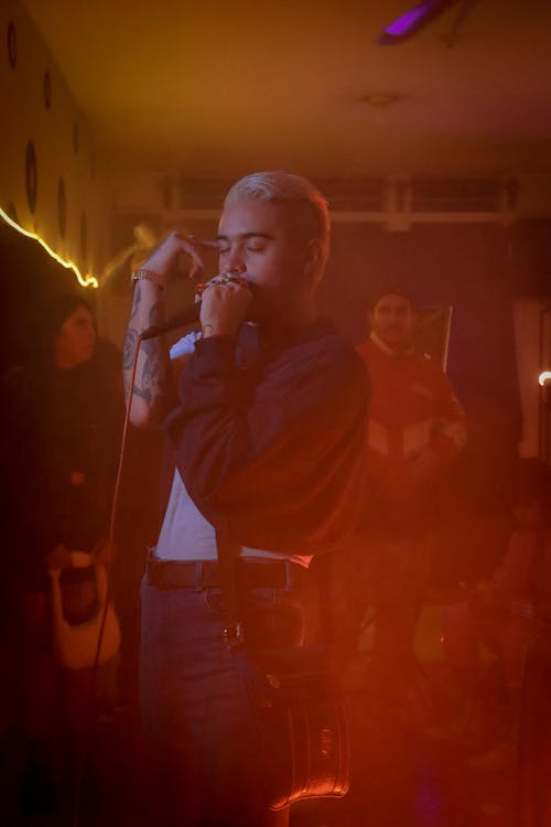 Young Man Singing in a Microphone at a Concert