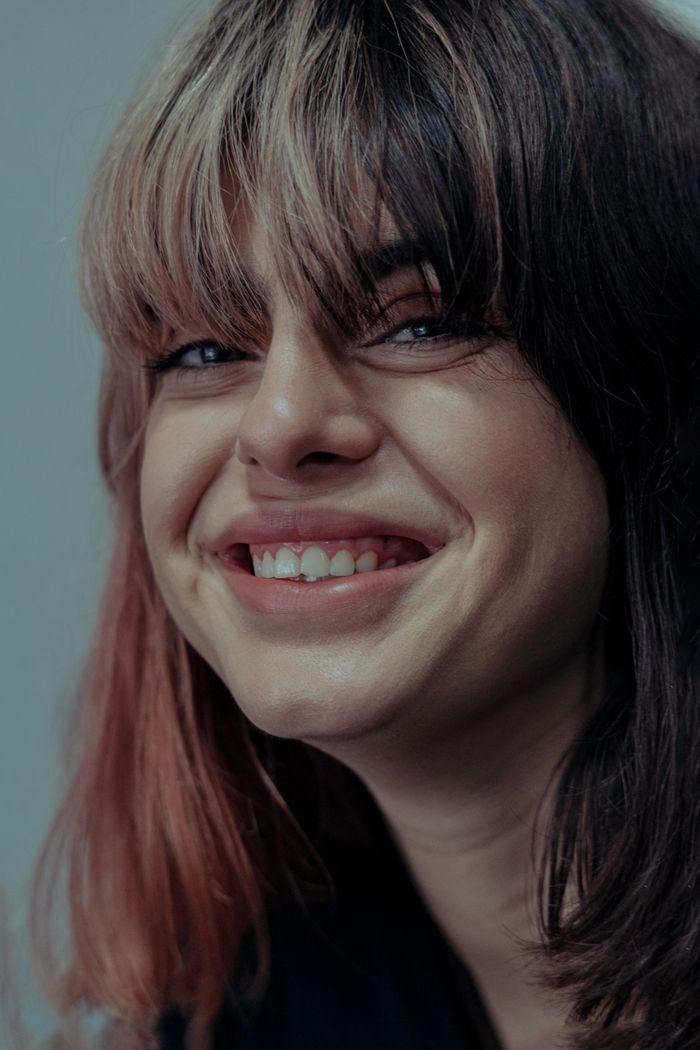 Smiling woman showing off her tooth gem