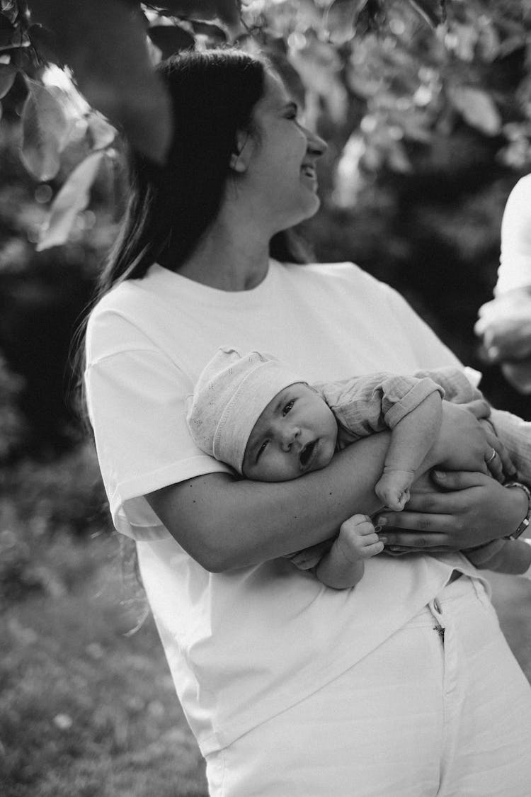 Black And White Photo Of A Young Mother Holding Her Newborn Baby