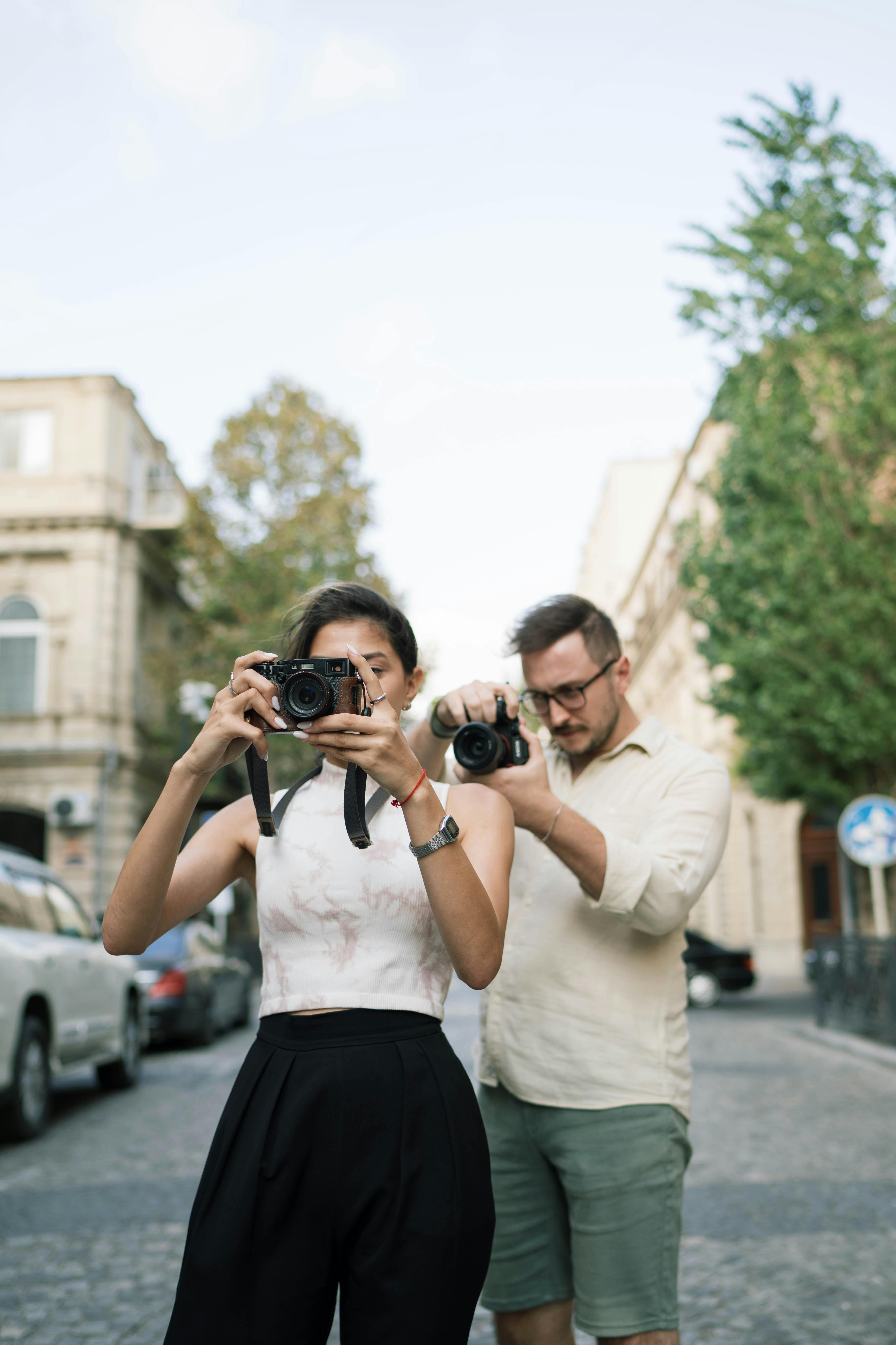 Woman Taking a Selfie with a Man Using a Camera · Free Stock Photo